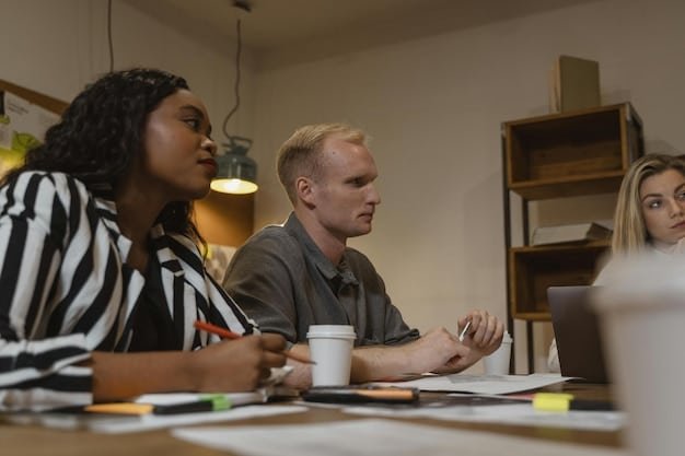 A close-up shot of a diverse group of individuals reviewing financial documents together around a table. The lighting is warm and professional, emphasizing collaboration and careful consideration.