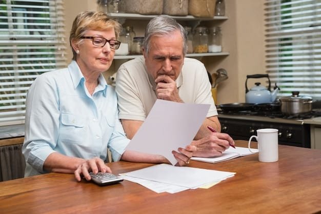 A senior couple reviewing financial documents at their home, with a calculator and a laptop nearby.