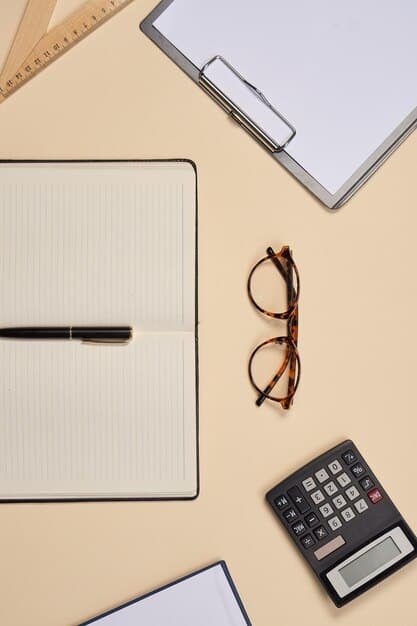 A close-up shot of a calculator, a pen, and financial documents on a desk, with a pair of reading glasses resting on top, emphasizing the planning aspect of senior care.