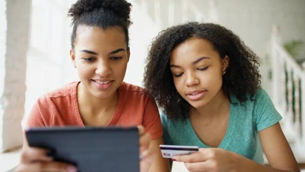 Two people discussing student loan repayment options, smiling and pointing at a tablet showing different financial scenarios.