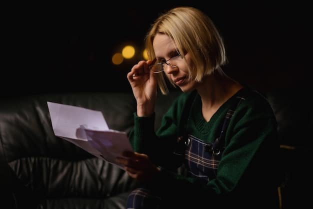 A person looking concerned at their credit card statement, with bills scattered around them. The scene is shot in a dimly lit room, emphasizing the stress and worry associated with financial difficulties.