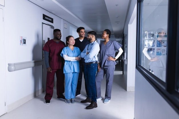 A diverse group of healthcare workers (nurses, doctors, and technicians) smiling and standing together in a hospital break room.