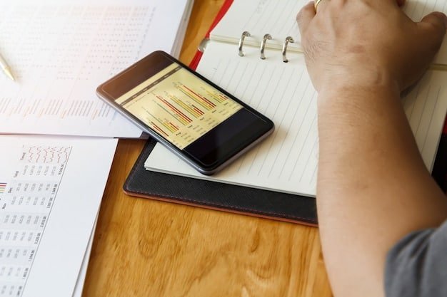 A person using a mobile app on their smartphone to track expenses, with graphs and charts displayed on the screen, illustrating the use of fintech for budgeting and financial tracking.