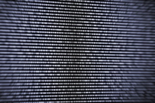 A close-up of a computer screen showing lines of complex code, with a faint overlay of scales of justice, symbolizing the need for fairness and transparency in AI algorithms.